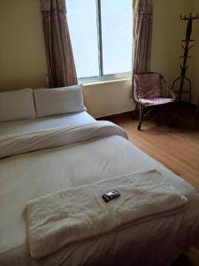 Una cama o camas en una habitación de Hotel Green Hill View
