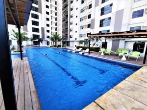 a large blue swimming pool in a building at Jojies Crib Horizons101 Studio in Cebu City