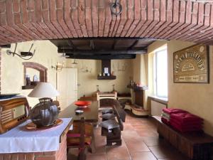 a living room with a table and chairs in a room at La Mondianese "House of Ruchè" in Montemagno