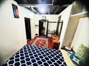 a bedroom with a blue and white bed and a mirror at Sardar Bahadur's Heritage Bungalow Estate Stay in Napoklu +69 photos