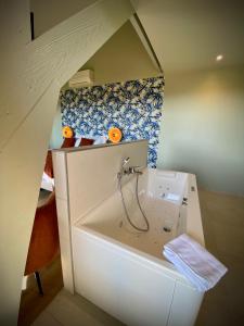 a small bathroom with a toilet and a sink at La Bellevue Bistrot et Chambres d'Hotes in Séné