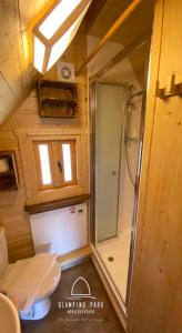 a small bathroom with a shower in a tiny house at Glamping Park in Mönichkirchen