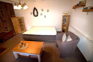 a room with a bed and a couch and a table at "Alte Schmiede" in Nordenham +25 photos