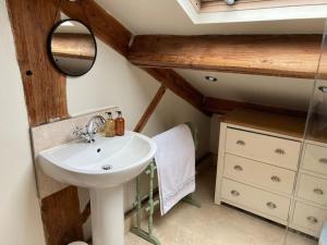 a bathroom with a sink and a mirror at The Hideaway in Ripponden