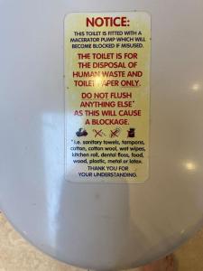 a label on the side of a toilet bowl at The Hideaway in Ripponden