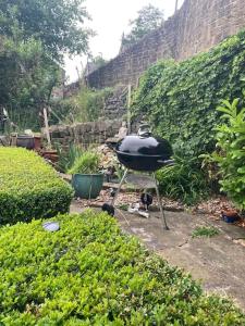 a grill sitting in the middle of a garden at The Hideaway in Ripponden