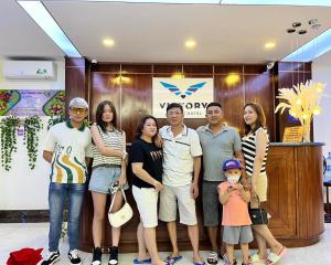 a group of people standing in front of a store at Victory Airport Hotel in Ho Chi Minh City