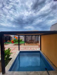 a swimming pool on the roof of a house at شالية الفضائل in Barka