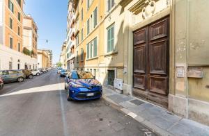 a blue car parked on the side of a street at Testaccino Case vacanze in Rome
