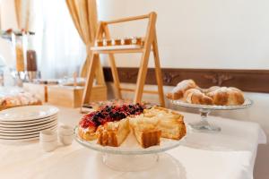 a table topped with two plates of pastries and croissants at Hotel & Restaurant Pahor in Doberdò del Lago