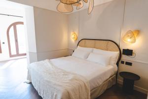 ORA Hotel Priorat, a Member of Design Hotels في Torroja: غرفة نوم بسرير أبيض وسقف