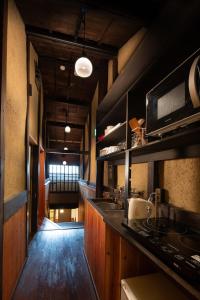 a kitchen with a sink and a counter top at Kanade Fushimiinari in Momoyama-chō