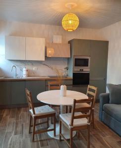 a kitchen with a table and chairs and a couch at Casina Elena - Viareggio centro in Viareggio