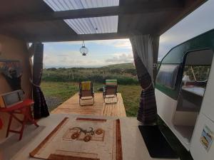 a view from the inside of a camper van with chairs at Father Ted Retro Caravan! in Drumaville