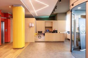 an office with yellow columns and a desk at B&B Hotel Milano Aosta in Milan