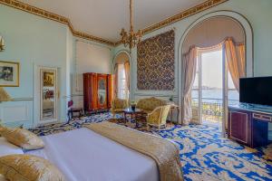 a bedroom with a bed and a large window at Le Metropole Luxury Heritage Hotel Since 1902 by Paradise Inn Group in Alexandria