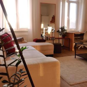 a living room with two beds and a table at CozyHome in Old Town, Presidential apartment in Bratislava