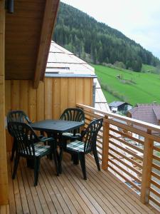 a table and chairs on the deck of a cabin at Appartement Luisa in Bad Kleinkirchheim