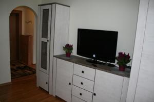a television on a white cabinet in a room at Cosy one room apartment in Vilnius