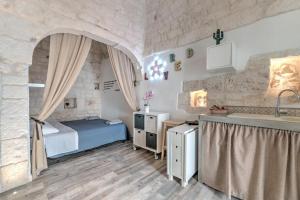 - une chambre avec un lit et un lavabo dans l'établissement Casa Anmori, à Ostuni