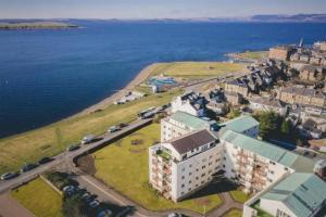 an aerial view of a building next to the water at Beachfront Penthouse, Largs in Largs