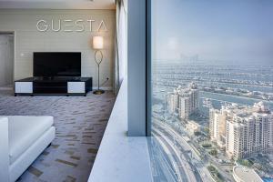a living room with a view of a city at The Palm Tower, Nakheel Mall, Palm Jumeirah in Dubai