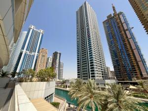 a view of a city skyline with tall buildings at HiGuests - Fabulous Duplex With Breathtaking Lake Views in Dubai