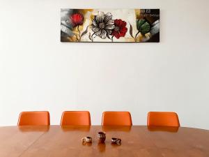 a conference room table with orange chairs and a painting at Комплекс «ТОП» in Sveti Vlas +52 photos