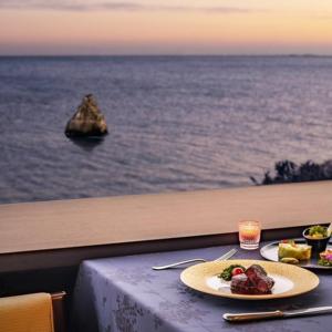 a table with a plate of food on top of the ocean at Onahama Ocean Hotel & Golf Club in Iwaki