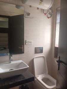 a bathroom with a white toilet and a sink at Hotel Presidency Inn in Kolkata