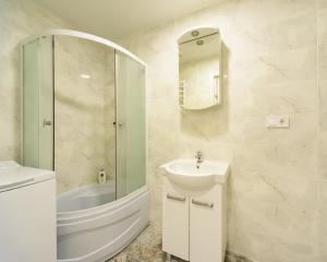 a white bathroom with a sink and a shower at Smart House 7 in Kyiv +64 photos