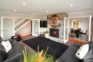 a living room with a couch and a fireplace at City Views on Rattray in Dunedin