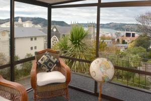 a balcony with chairs and a view of a city at City Views on Rattray in Dunedin