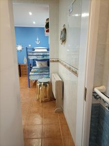 a hallway with a room with a bed and a stool at Estúdio Mário Fanha in Nazaré