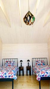 um quarto com duas camas e um lustre em Domek Dzikie Lisko em Lesko