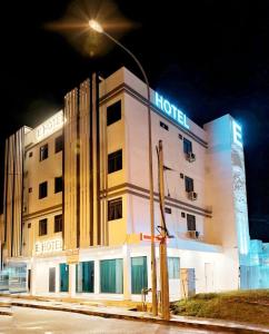 un edificio de hotel con una luz de la calle delante de él en E Hotel en Kulim