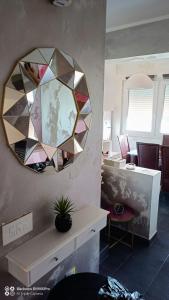 a mirror hanging on a wall in an office at Apartman Bella Vista in Golubac