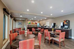 a restaurant with tables and chairs and a counter at Quality Inn & Suites in Ocean City
