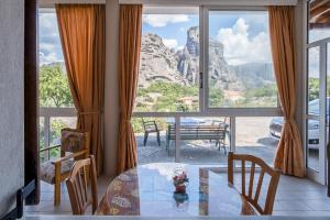 a dining room with a table and a view of a mountain at Majestic view Home just under Meteora Unesco Site in Kalabaka