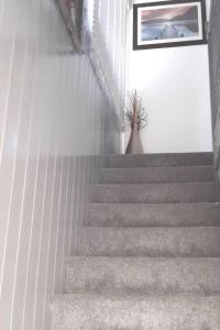 a set of stairs with a potted plant on it at Beautiful and modern House in Gravesend in Gravesend