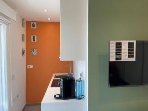 a kitchen with a black appliance on a counter at LOUXORY ACCOMODATION CAGLIARI in Cagliari