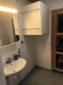 La salle de bains est pourvue d'un lavabo et d'un miroir. dans l'établissement FREE Sauna and Laundry, 5min to Metro, 15min to Center, à Espoo