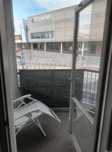 a view from a window of a building with a surfboard at FREE Sauna and Laundry, 5min to Metro, 15min to Center in Espoo