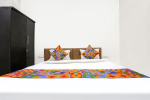 a bedroom with a bed with a colorful bedspread at FabHotel Destiny 74 in Indore