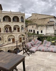 a group of pillows on a patio in an old building at Glamada Cave Suites in Urgup