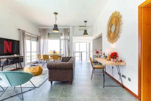 a living room with a couch and a table at Villa Horizon in Caleta De Fuste