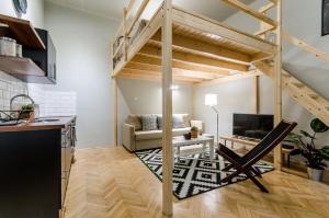 a loft apartment with a staircase and a living room at Sweet Cumin Apartment Next To Famous Cafe in Budapest
