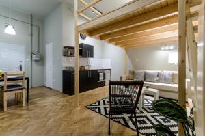 a living room with a kitchen and a dining room at Sweet Cumin Apartment Next To Famous Cafe in Budapest