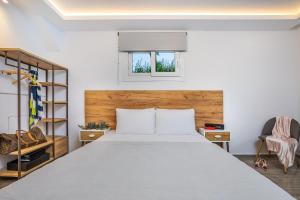 a bedroom with a large bed and a window at Albero Villa Polychrono in Polykhrono