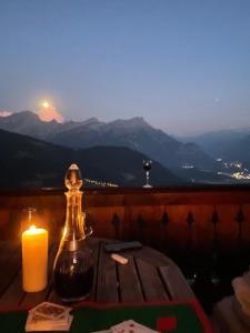 een kaars op een tafel met uitzicht op de bergen bij Magical Hideaway in Leysin